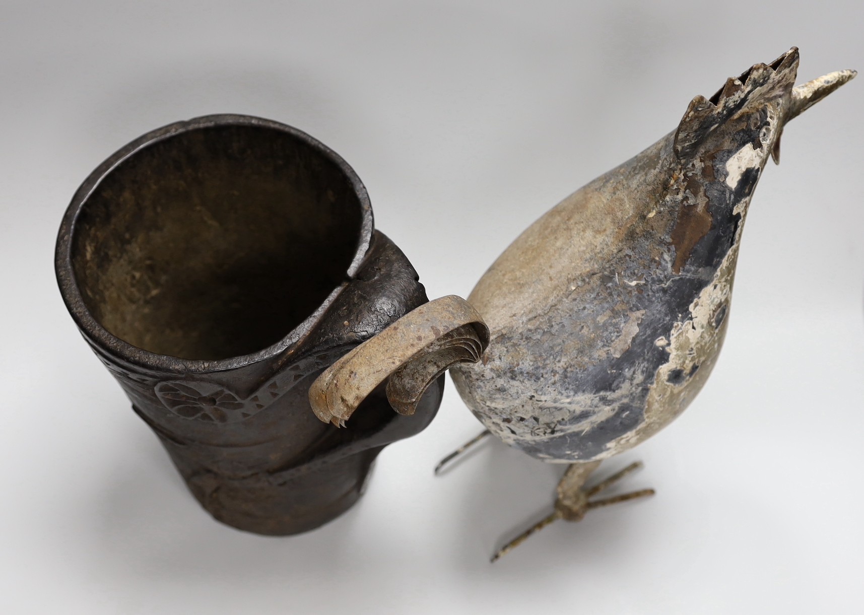 An 18th century Scandinavian carved wood tankard and a 19th century painted tin plated iron model of a cockerel, 36.5cm high.